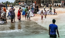 People standing on the shore of a tropical island